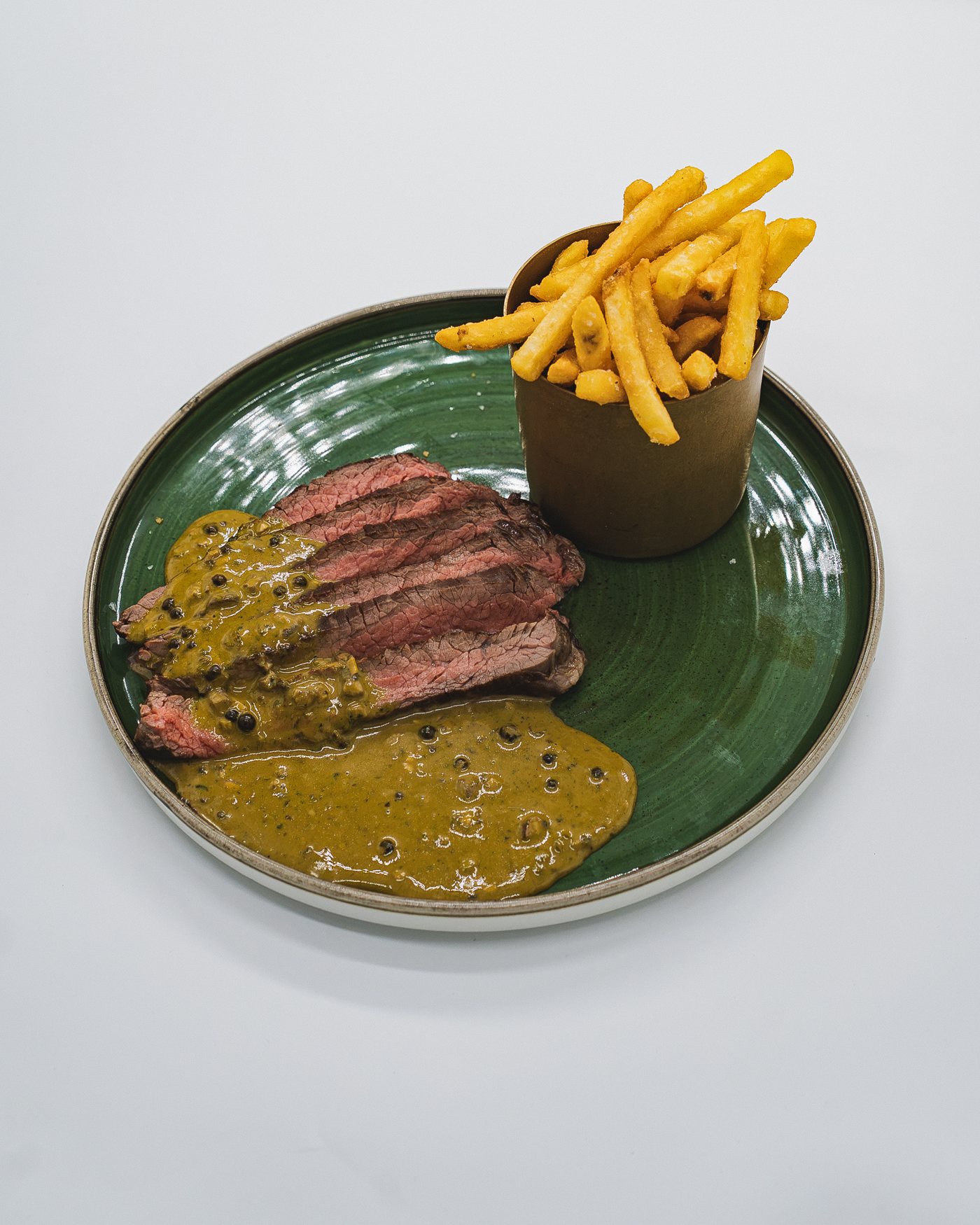 Sliced steak frites with pepper sauce and fries